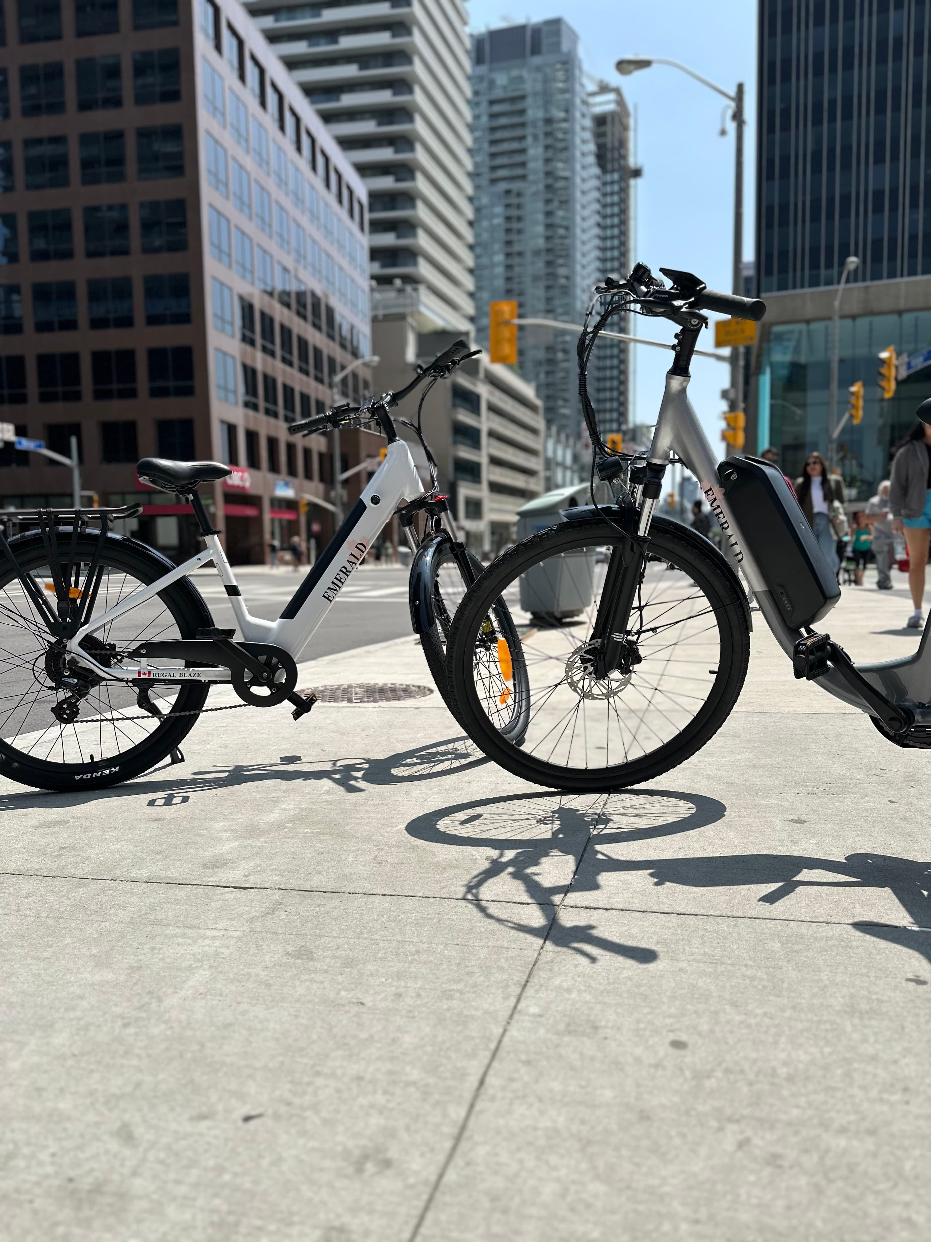 Two Regal Series e-bikes crossing downtown Toronto
